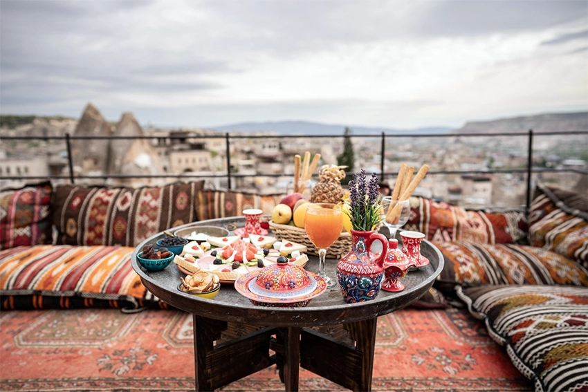 Traditional Anatolian breakfast table with cheeses, honeycomb, olives, and tea in Cappadocia