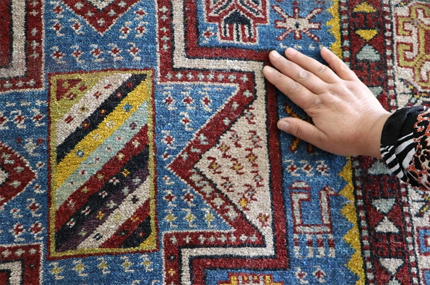 Close-up of Anatolian carpet motifs symbolizing fertility and protection