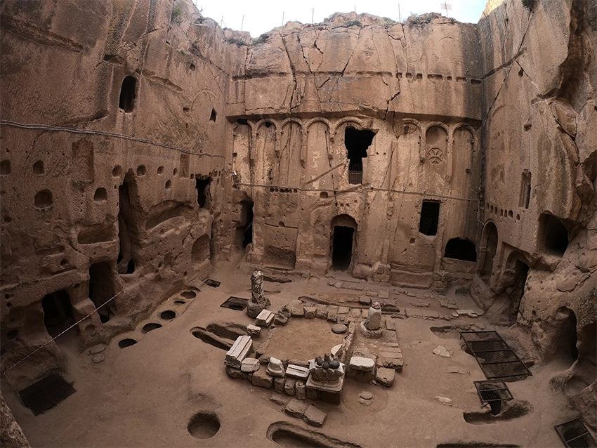 Exterior view of Gümüşler Monastery carved into rock in Niğde