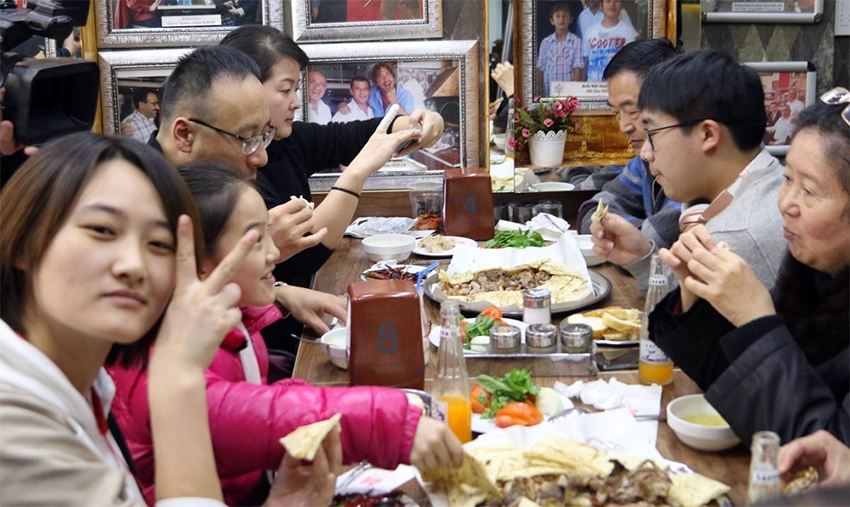 Guests watching tandır kebab cooking process in a traditional restaurant in Cappadocia