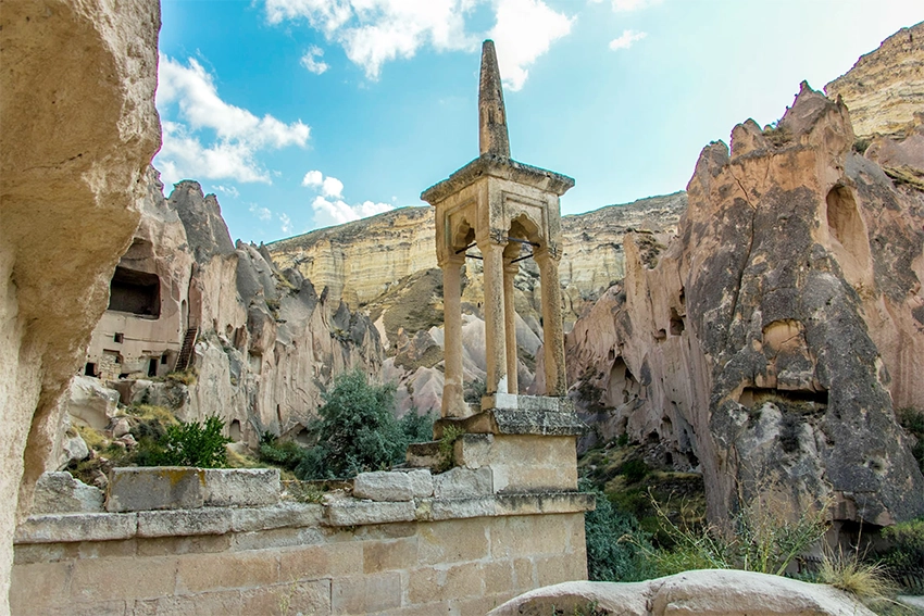 Rock-carved mosque with baldachin-style minaret in Zelve