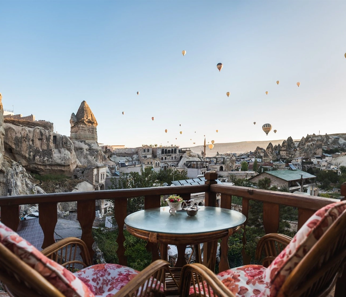Cave hotel terrace with hot air balloon views in Cappadocia