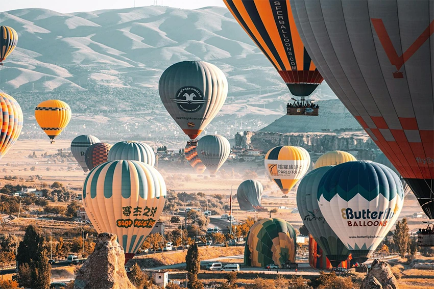 Cappadocia panoramic landscape with balloons and fairy chimneys at sunrise