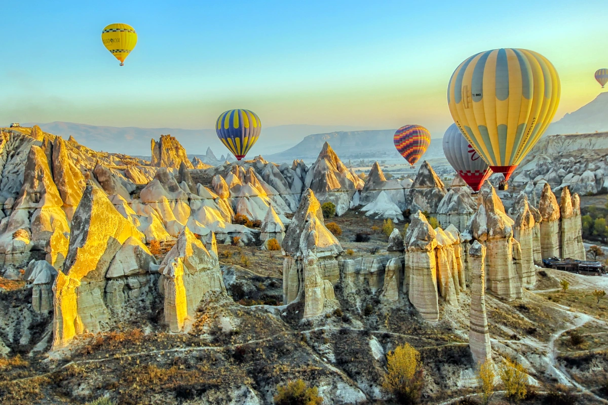 Cappadocia panoramic landscape view at sunrise with balloons over fairy chimneys