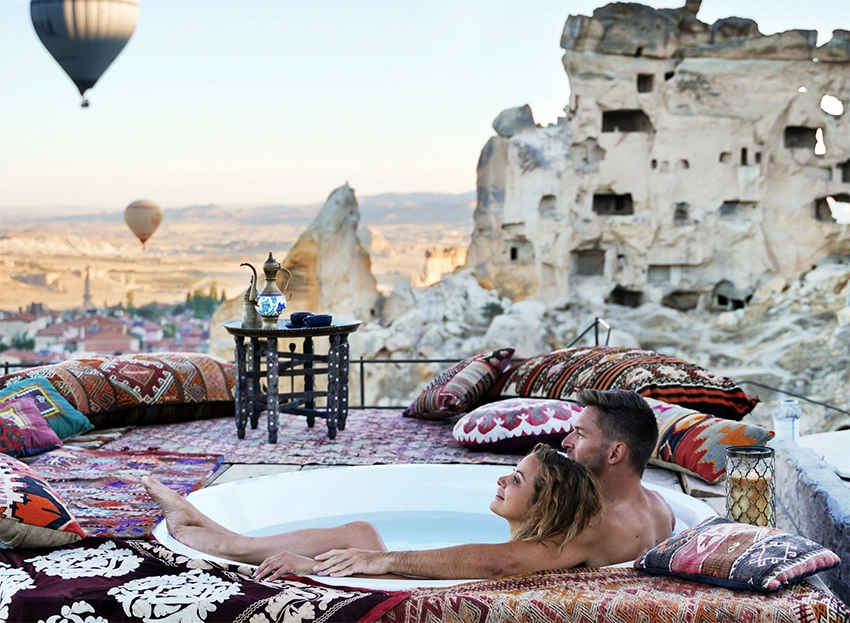 Luxury Cappadocia panorama with balloons, terraces and cave hotels